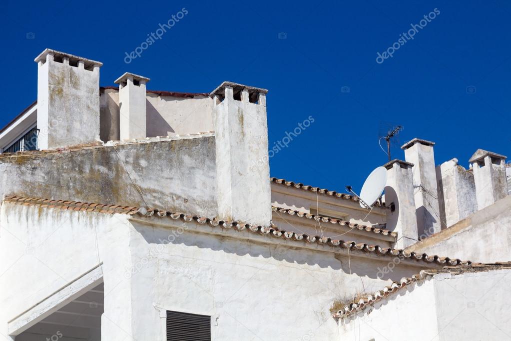 Chimneys on the roofs of some white houses