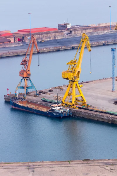 Huge cranes at a port charge — Stock Photo, Image