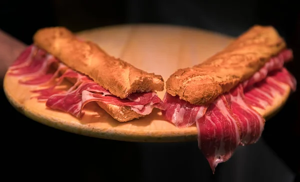 Serrano iberico ham sandwiches on a platter at a local shop in Pamplona Spain — Stock Photo, Image