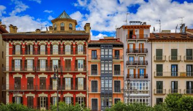 Ornate facades of buildings on Historic Plaza del Castillo with restaurants and cafes in Old Town Pamplona, Spain famous for running of the bulls
