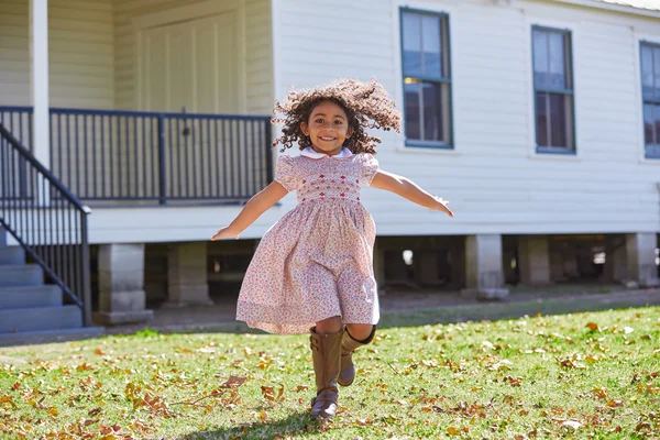 Kid girl running in park with flowers dress — Stock Photo, Image