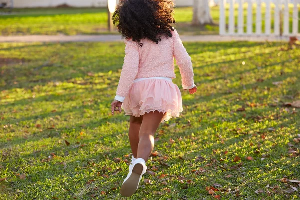 Kid girl toddler playing running in park rear view — Stock Photo, Image
