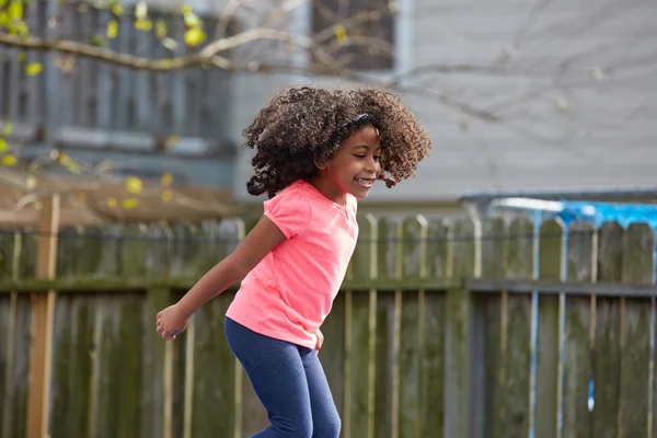Kind peuter meisje springen op een speeltuin — Stockfoto