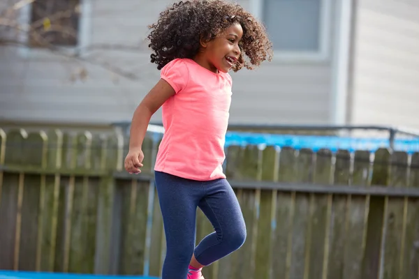 Kid toddler girl jumping on a playground — Stock Photo, Image