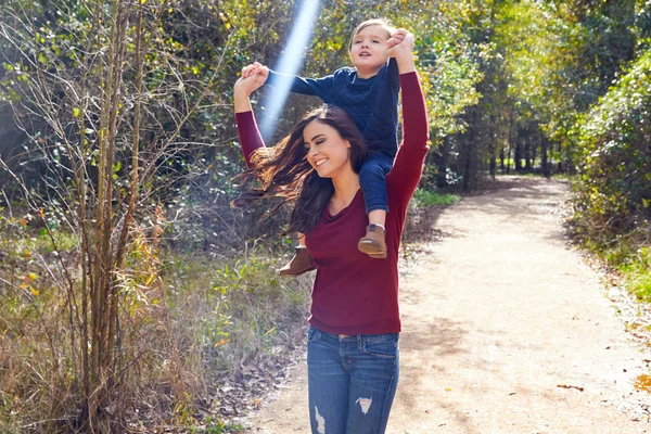 Menino sentar-se nos ombros mãe andar parque — Fotografia de Stock