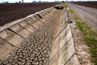 Dried irrigation ditch clay soil in Albufera fields clipart