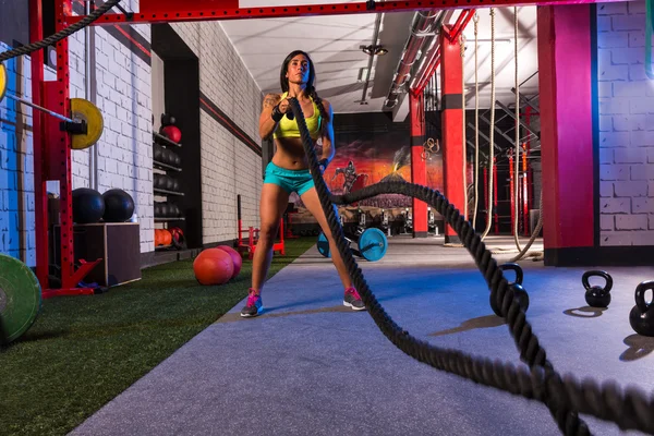 Battling ropes girl at gym workout exercise — Stock Photo, Image