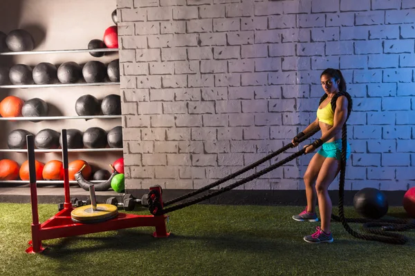 Sled rope pull woman pulling weights workout — Stock Photo, Image