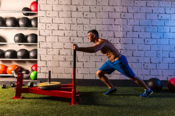 Sled push man pushing weights workout — Stock Photo, Image