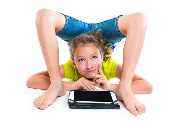 Contortionist kid girl thinking gesture with tablet pc — Stock Photo, Image