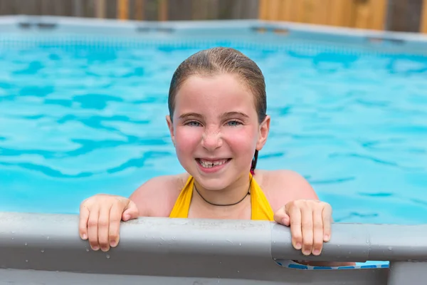 Blond girl swimming in the pool with red cheeks — Stock Photo, Image