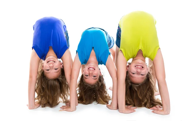 Twin kid sisters playing as flexible contortionist — Stock Photo, Image