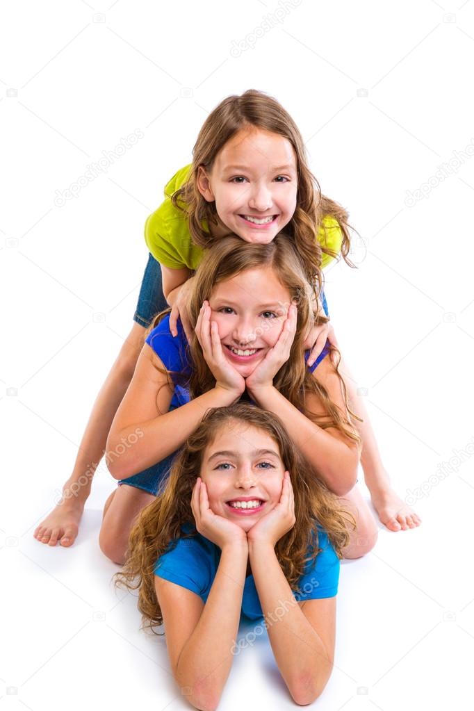 Three kid girls friends happy stacked in a row
