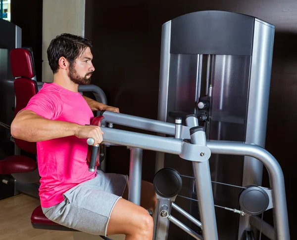 Arka sıradaki makine adam egzersiz spor salonunda oturmuş — Stok fotoğraf