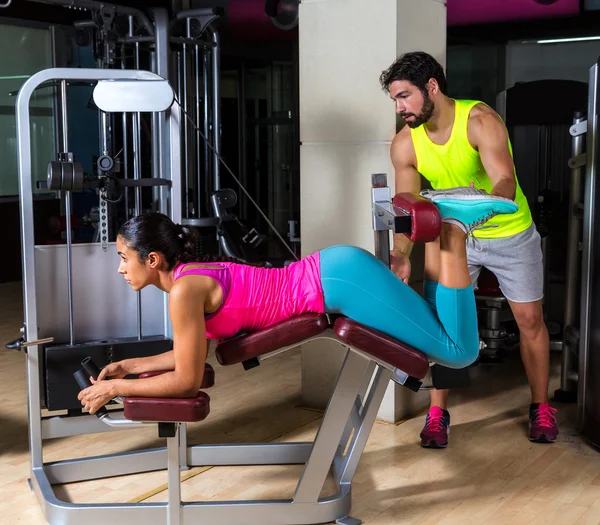 Lying hamstring curl machine girl — Stock Photo, Image