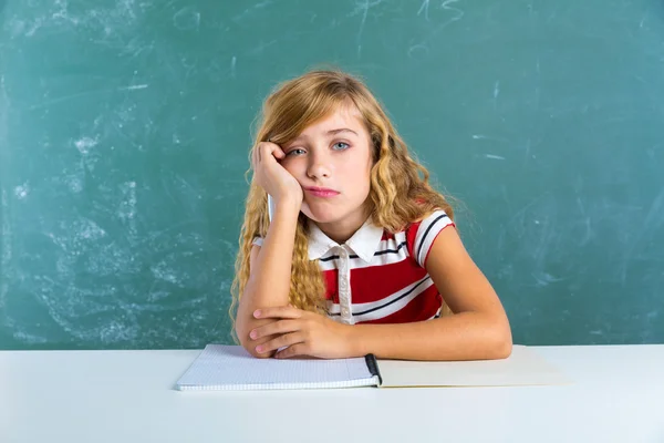 Скучное грустное выражение лица школьницы на столе — стоковое фото