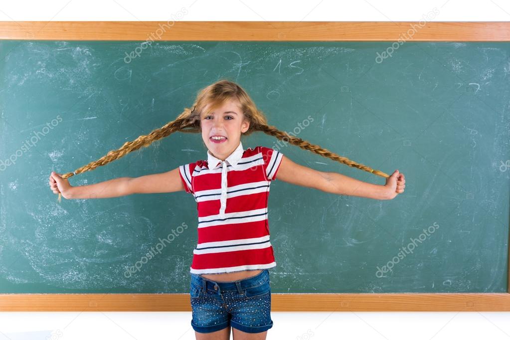 Braided student blond girl playing with braids