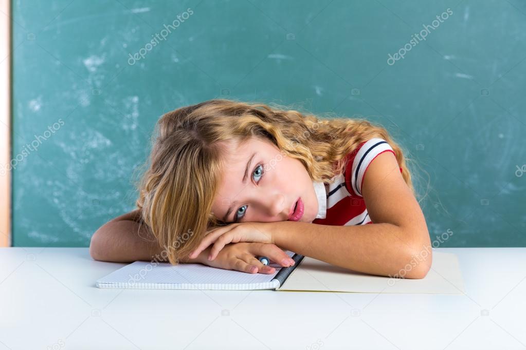 Boring sad expression student schoolgirl on desk