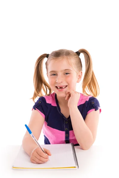 Blond kid girl student with spiral notebook in desk — Stock Photo, Image