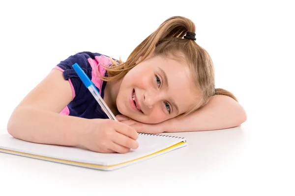 Blond liten flicka student med spiral notebook i skrivbord — Stockfoto