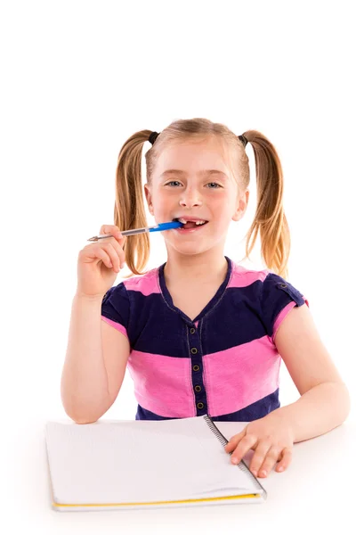 Blond kid girl student with spiral notebook in desk — Stock Photo, Image