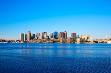 Boston skyline with river sunlight Massachusetts clipart