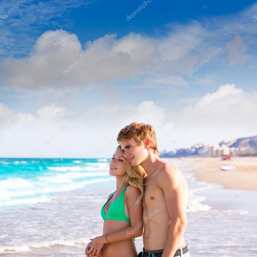 Blond couple of young tourists in a tropical beach