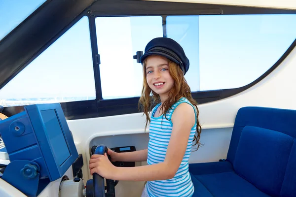 Kid girl pretending be a captain sailor cap in boat — Stock Photo, Image