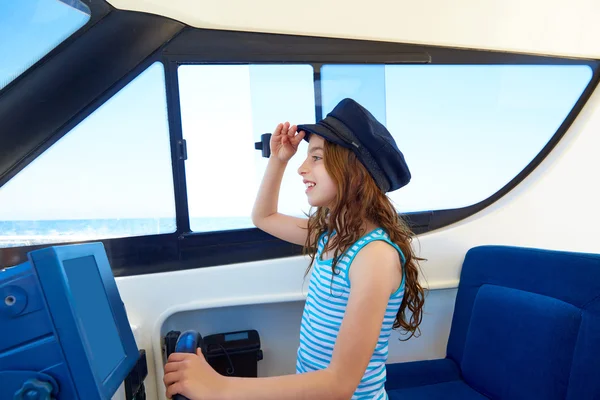 Kid girl pretending be a captain sailor cap in boat — Stock Photo, Image