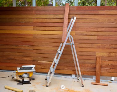 Ipe wood fence installation carpenter table saw clipart