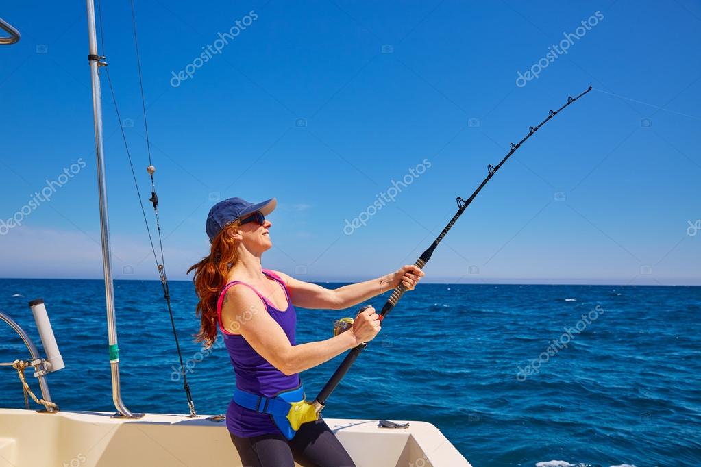 Beautiful woman girl fishing rod trolling in boat Stock Photo by  ©lunamarina 75546245