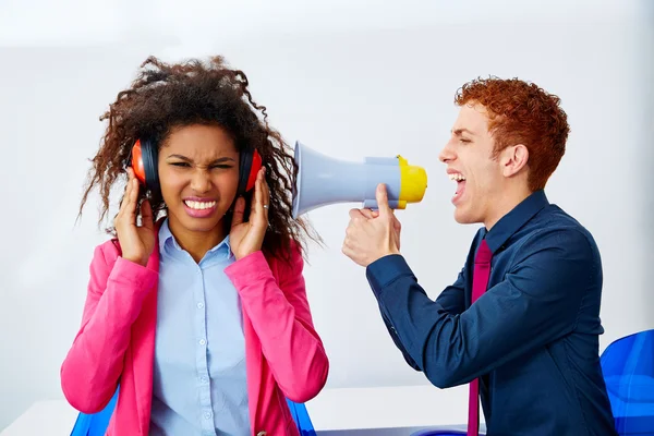 Businessman shouting megaphone to african woman — Stock Photo, Image