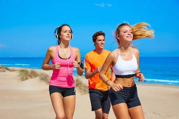 Vrienden die op het strand gelukkig in de zomer worden uitgevoerd — Stockfoto