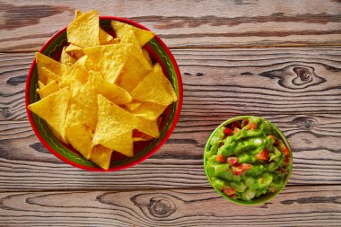 Guacamole with avocado tomatoes and nachos clipart