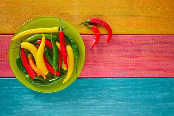 Colorful mexican chili peppers on wood table — Stock Photo, Image