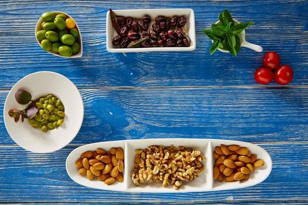 Tapas mediterráneas aceitunas negras alcaparras y nueces — Foto de Stock