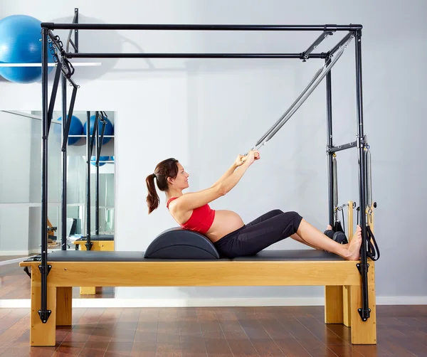 Pregnant woman pilates reformer roll up exercise — Stock Photo, Image