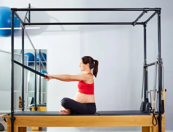 Pregnant woman pilates reformer forward push — Stock Photo, Image