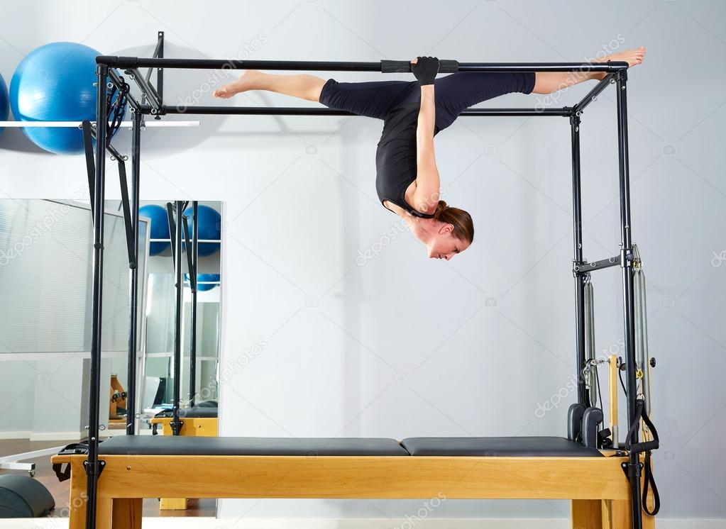 Pilates woman in cadillac walk over reformer — Stock Photo © TONO