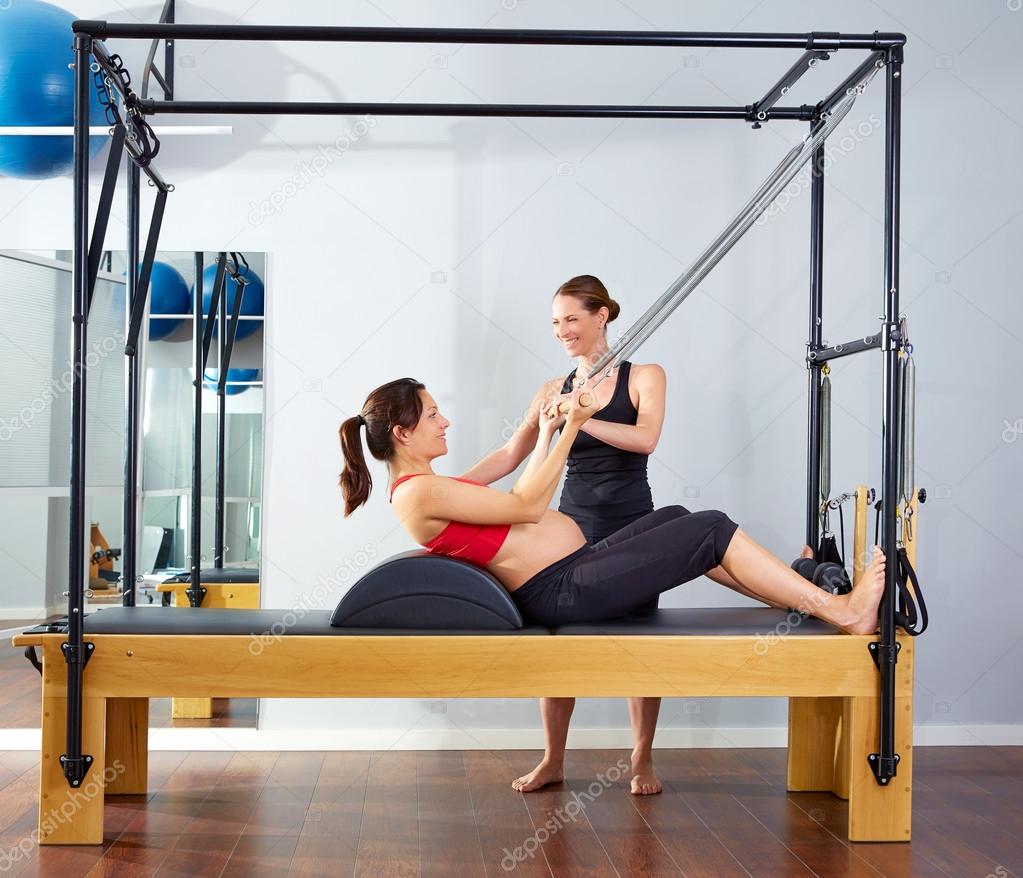 pregnant woman pilates reformer roll up exercise