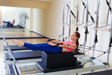 Pilates reformer woman back stroke exercise