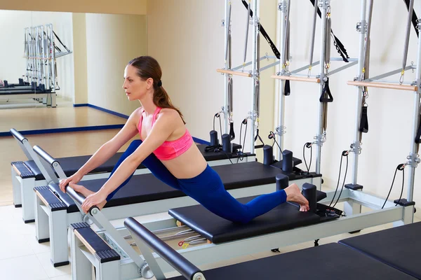 Pilates reformer woman front split exercise — Zdjęcie stockowe