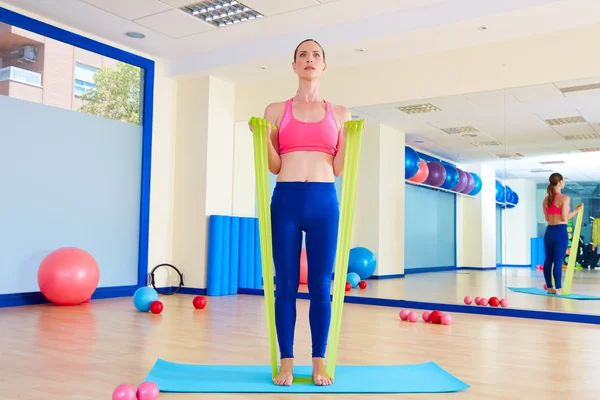 Pilates woman biceps rubber band exercise — Stock Photo, Image