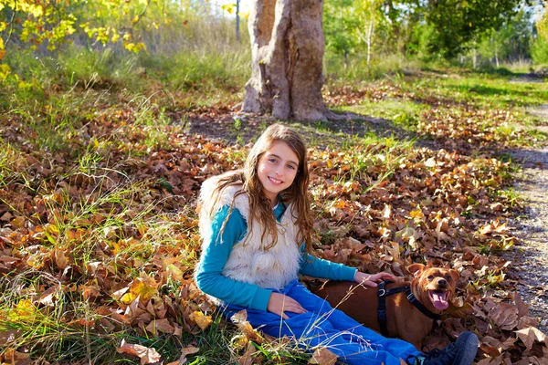 Autumn kid girl with pet dog relaxed in fall forest — Stock Photo, Image