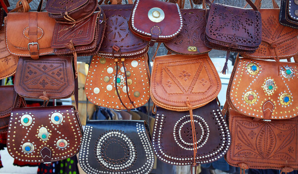 Moroccan leather goods bags in a row at market