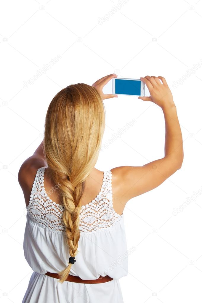 Blond tourist girl taking photos with smartphone