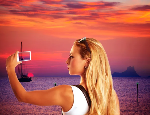 Blonde Touristin fotografiert Sonnenuntergang mit dem Smartphone — Stockfoto