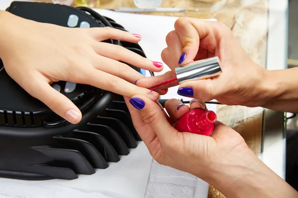 Nails painting with UV dry lamp in blue light — Stock Photo, Image