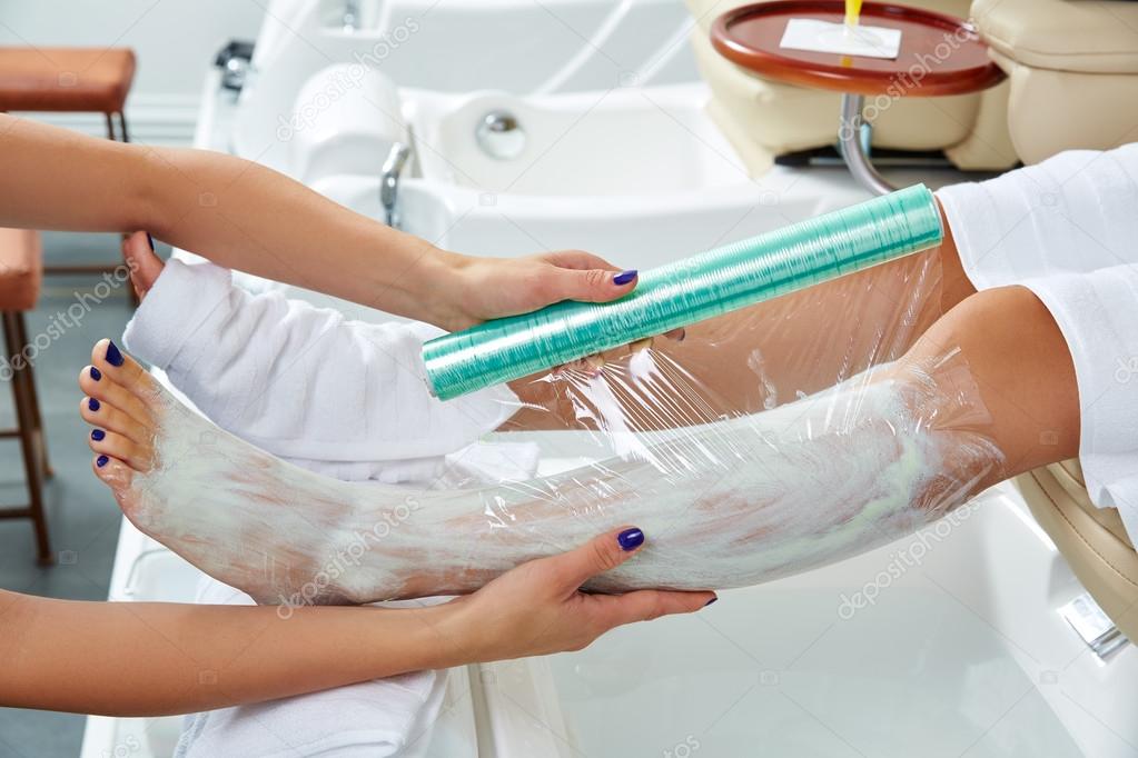 Pedicure nourishing mask legs cling film wrap — Stock Photo