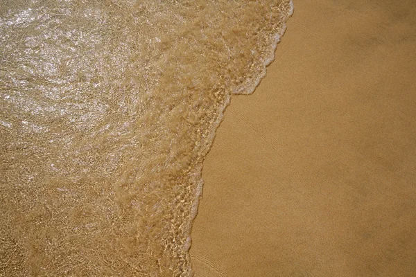 Praia água e areia textura fundo — Fotografia de Stock